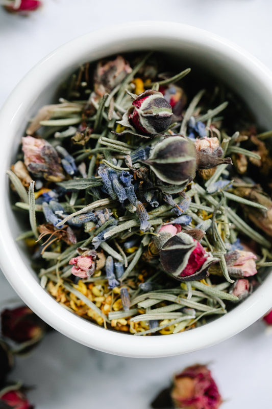 a bowl of various colorful dried herbs