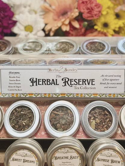 The Herbal Reserve box open, showing five labelled tins of loose leaf tea including Sweet Dreams, Breathe Easy and Sunrise Brew