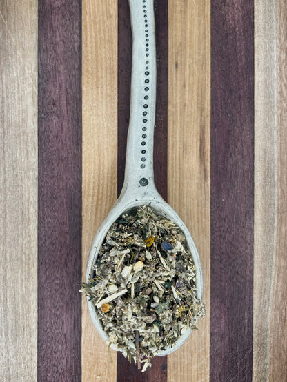 Pale blue spoon holding the Sweet Dreams bedtime blend of valerian, chamomile, mugwort and lavender