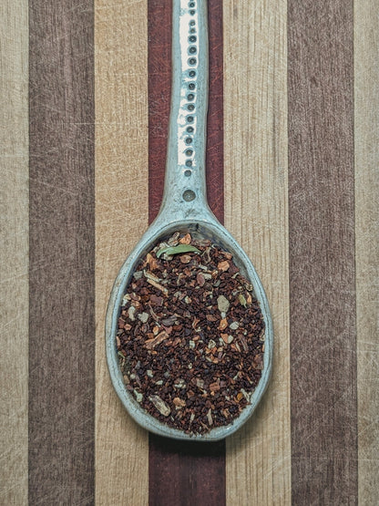 Pale blue spoon holding the dark roasted Sunrise Brew blend of chicory and dandelion root